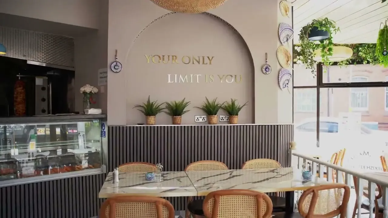 Arched wall with gold lettering and the counter