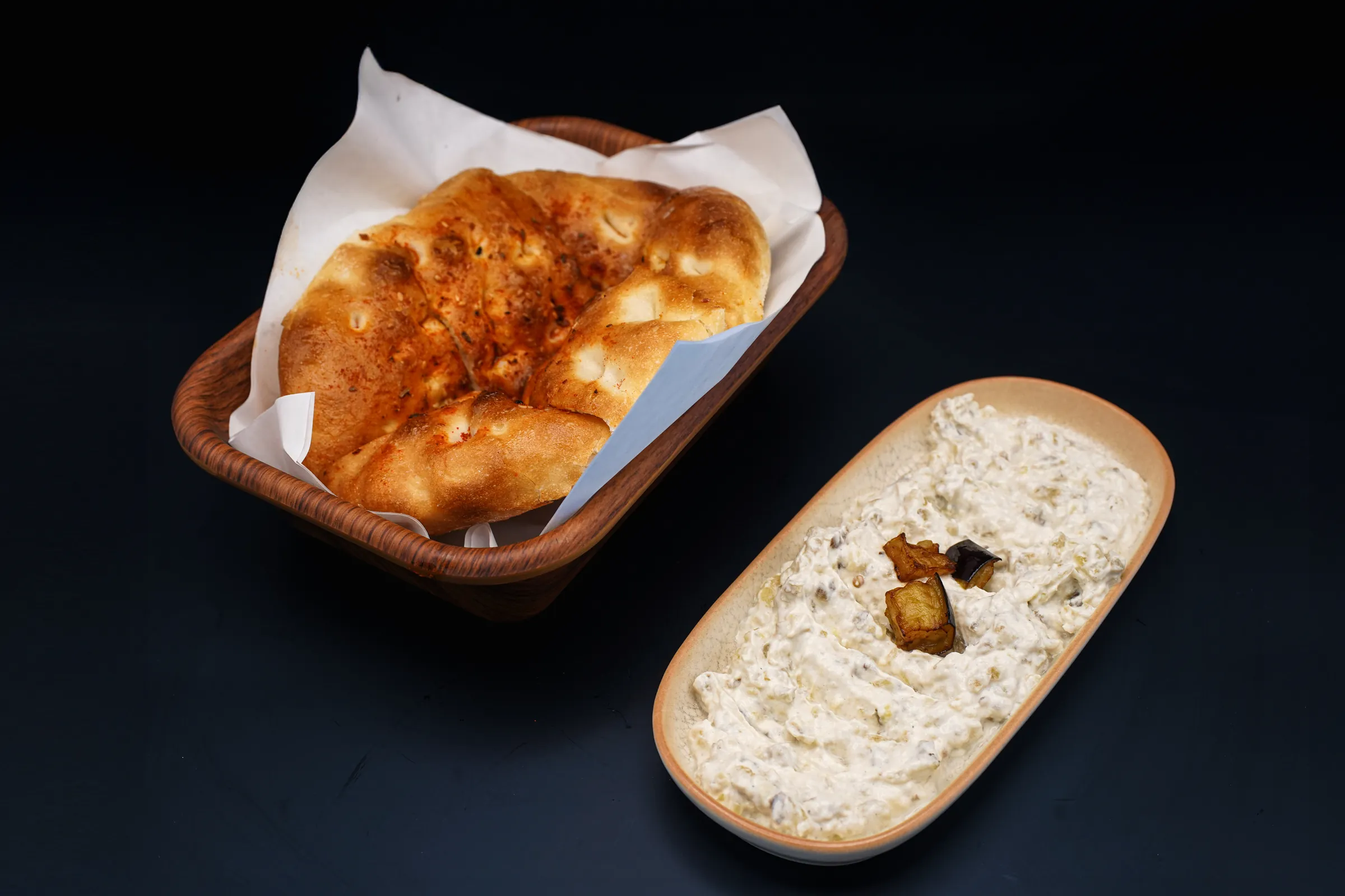 Warm Turkish bread in a basket beside a creamy dip