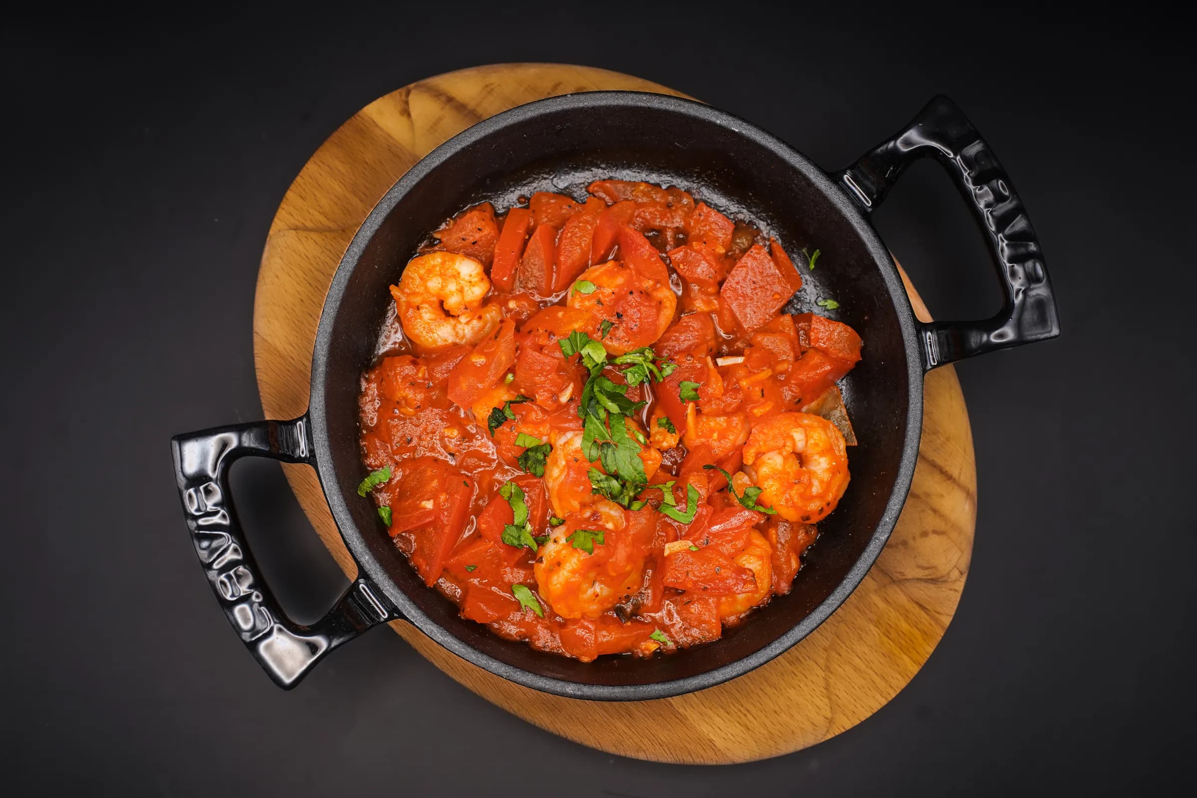 Prawns in a rich tomato sauce, served in a cast-iron pan